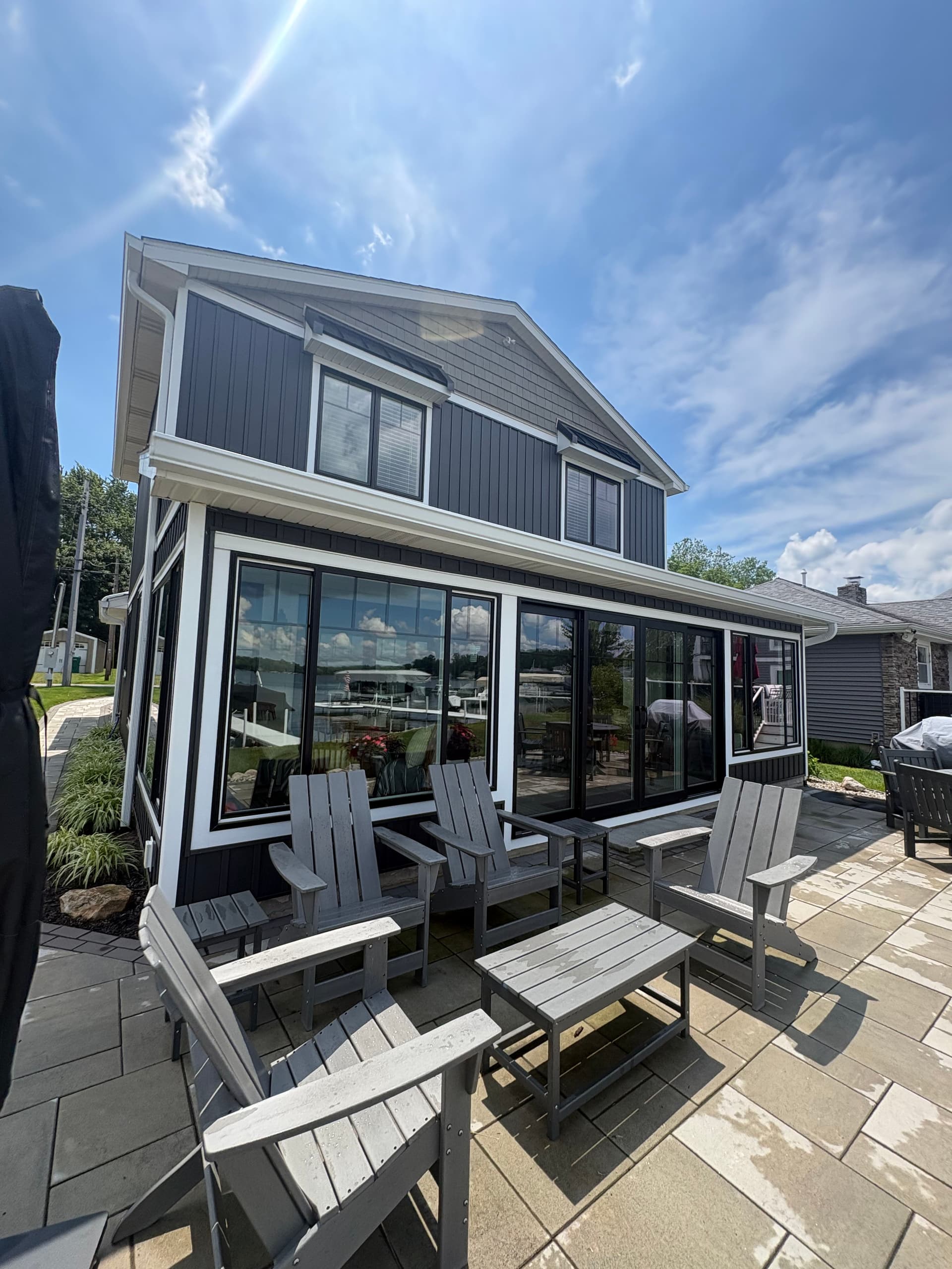 Dark Board and Batten Siding and Gutter Install on a Lakefront Home image